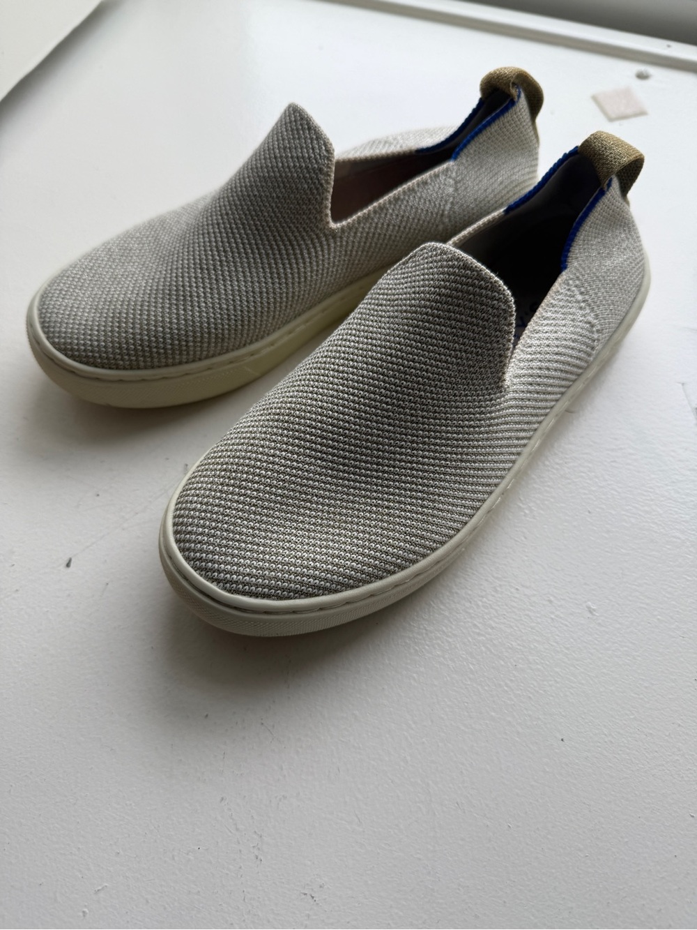 Rothy's Slip-On Knit Sneakers in Light Gray and Blue Trim